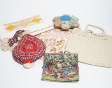 A collection of 20th century embroidered bags, a patchwork pin cushion, a beadwork mat, etc.