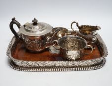 A matched Victorian repousse silver four piece bachelor's tea set, gross 12.8oz and silver plated
