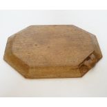 A Robert ‘Mouseman’ Kilburn octagonal carved oak breadboard, 30x25cm