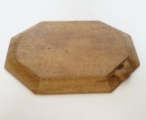 A Robert ‘Mouseman’ Kilburn octagonal carved oak breadboard, 30x25cm