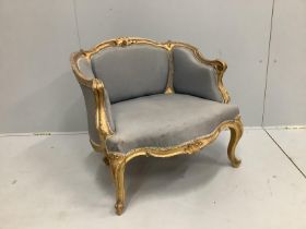 A Victorian carved giltwood and composition upholstered salon chair, width 70cm, depth 60cm,