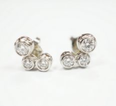 A modern pair of Tiffany & Co platinum and three stone graduated diamond set ear studs, 10mm,