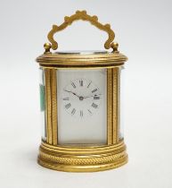 * * A late 19th French miniature engraved oval cased carriage timepiece, height 7cm Please note this