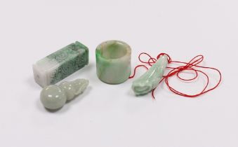 Four Chinese jadeite carvings including an archers ring