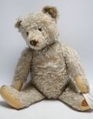 Steiff bear, c.1950's, button and label, 50cm, one ear loose, holes to paw pads, small patch of wear