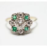 A yellow metal, diamond and emerald set flower head cluster ring, size P, gross weight 4 grams,