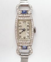 A lady's mid 20th century white metal (Swiss platinum mark), sapphire and diamond cluster set manual
