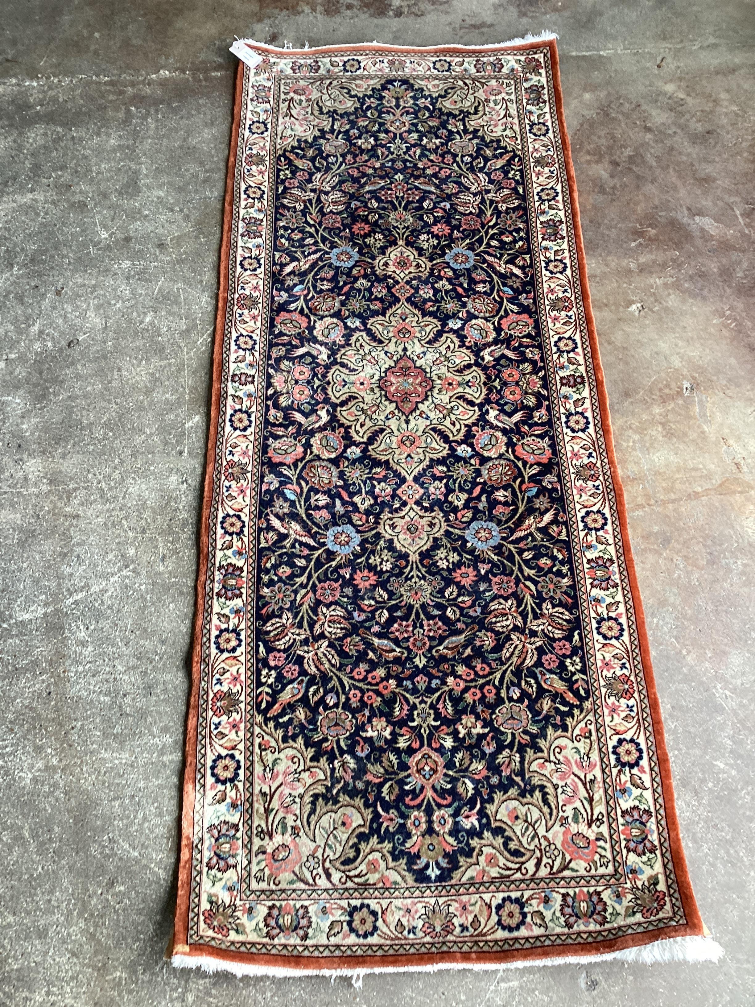 ** ** A modern Persian dark blue ground runner, 185 x 70cms Please note this lot attracts an