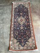 ** ** A modern Persian dark blue ground runner, 185 x 70cms Please note this lot attracts an