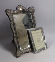 * * A modern Victorian style embossed silver easel framed mirror, 37cm and a smaller modern silver
