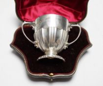 A cased Edwardian silver two handled christening cup, with engraved inscription, Wakely & Wheeler,