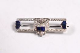 A 1980's Art Deco style Garrard 18ct white gold, sapphire and diamond cluster set bar brooch,