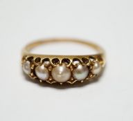 A Victorian yellow metal and graduated split pearl set half hoop ring, size S, gross weight 4
