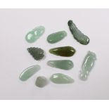 Ten various Chinese carved jadeite pendants