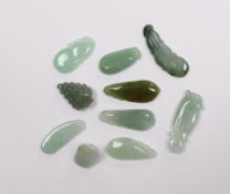 Ten various Chinese carved jadeite pendants