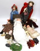 Nine assorted dolls including AMS and Kewpie small doll baby in cradle