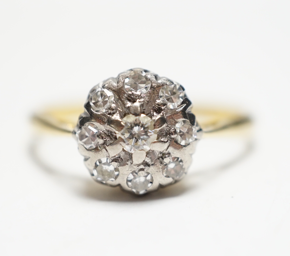 A 1960's 18ct gold and diamond cluster set flower head ring, size N/O gross weight 2.3 grams.