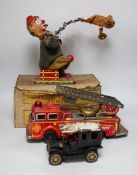 Four tinplate toys; a model of a 1920s taxi, a 1960s German made fire engine, an automaton clown,