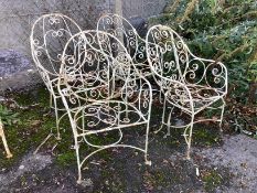A set of four painted wrought metal garden chairs