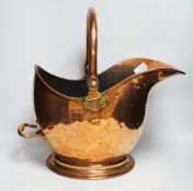 * * A Victorian copper coal helmet, 35cm wide including handle Please note this lot attracts an