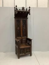 A Gothic style carved oak throne chair with hinged box seat, width 69cm, depth 53cm, height 230cm