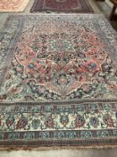An early 20th century Heriz burgundy ground carpet, 380 x 276cm