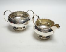 * * A George VI silver two handled sugar bowl and matching cream jug, Walker & Hall, Sheffield,