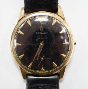 A gentleman's 9ct gold Omega manual wind black dial wrist watch (lacking winding crown), on