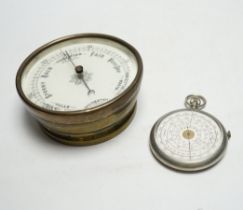 An aneroid barometer and a pocket calculator, calculator 11cm high