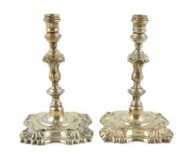 A pair of George V silver tapersticks by Sebastian Garrard for Garrards, London, 1934, with engraved