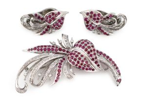 A suite of platinum?, diamond and ruby set cluster jewellery, comprising a spray brooch and pair