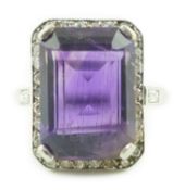 A mid 20th century platinum?, amethyst and diamond set cluster ring, the central emerald cut