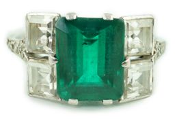 An Art Deco platinum, emerald and square cut diamond dress ring, with diamond chip set shoulders,