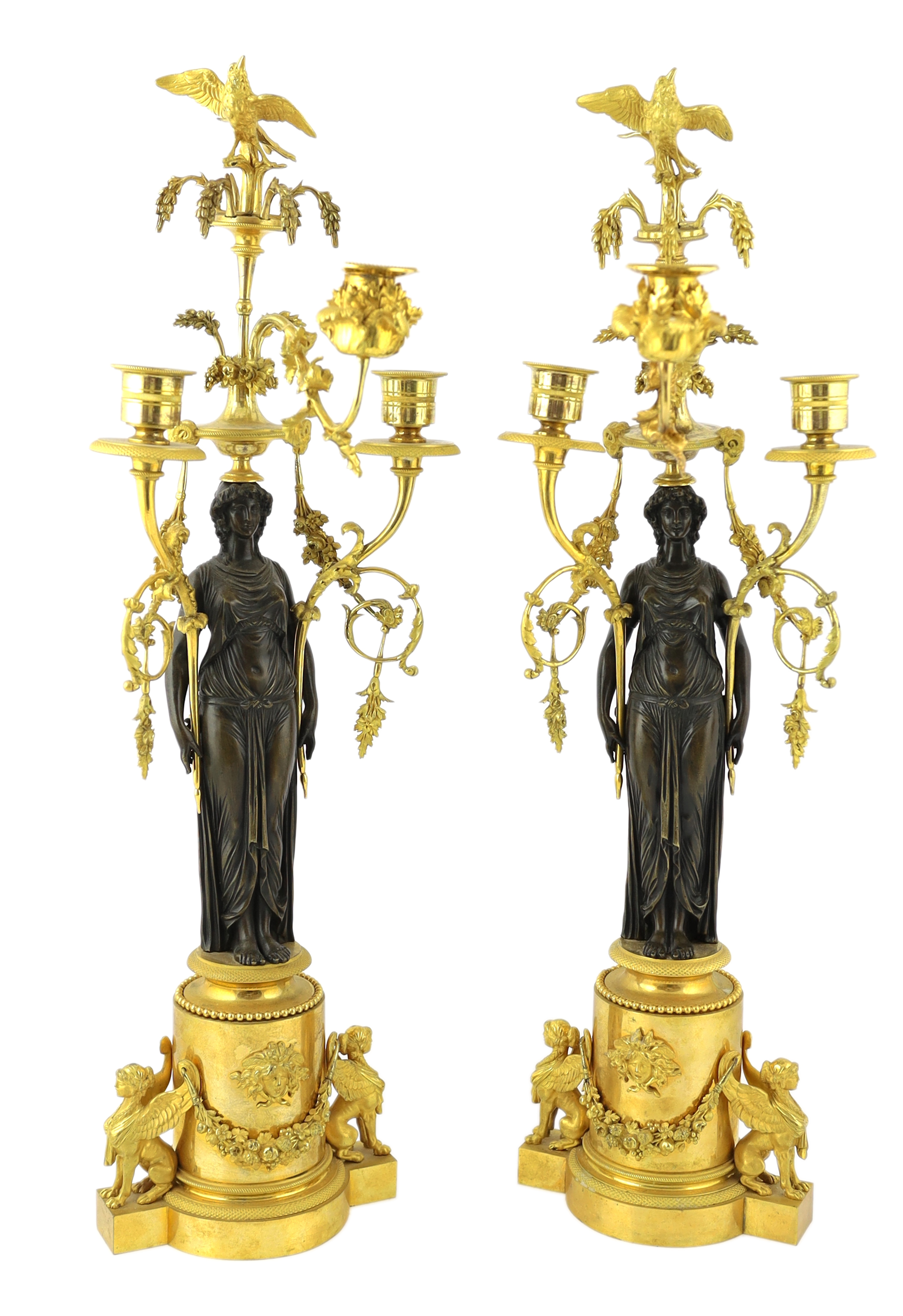 * A pair of late 19th century French Empire style bronze and ormolu three light candelabra, with