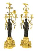 * A pair of late 19th century French Empire style bronze and ormolu three light candelabra, with