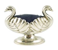 A late Victorian novelty silver pin cushion, modelled as a double headed swan, makers mark rubbed,