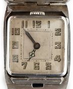 A gentleman's late 1920's silver flip action manual wind rectangular wrist watch, with part engine