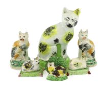 Six Staffordshire pearlware models of cats, early 19th century, comprising a pair of cats and a