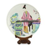 * A Chinese famille rose saucer dish, Yongzheng period, painted in enamels with a young woman