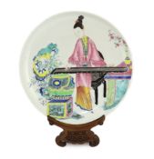 * A Chinese famille rose saucer dish, Yongzheng period, painted in enamels with a young woman