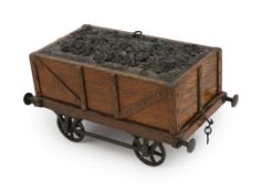 An Edwardian novelty oak smoker's compendium modelled as a railway tender, with simulated coal
