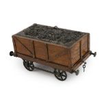 An Edwardian novelty oak smoker's compendium modelled as a railway tender, with simulated coal
