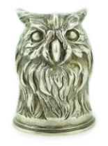 An early 20th century Russian 84 zolotnik 'stirrup' cup, modelled as the head of an owl, maker H.W.,