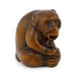 * A Japanese carved wood netsuke of an ape, Tamba School, 19th century, with inlaid eyes, 3.