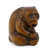 * A Japanese carved wood netsuke of an ape, Tamba School, 19th century, with inlaid eyes, 3.