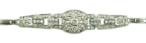 A 1950's platinum and diamond cluster set expanding link bracelet, the largest stone diameter