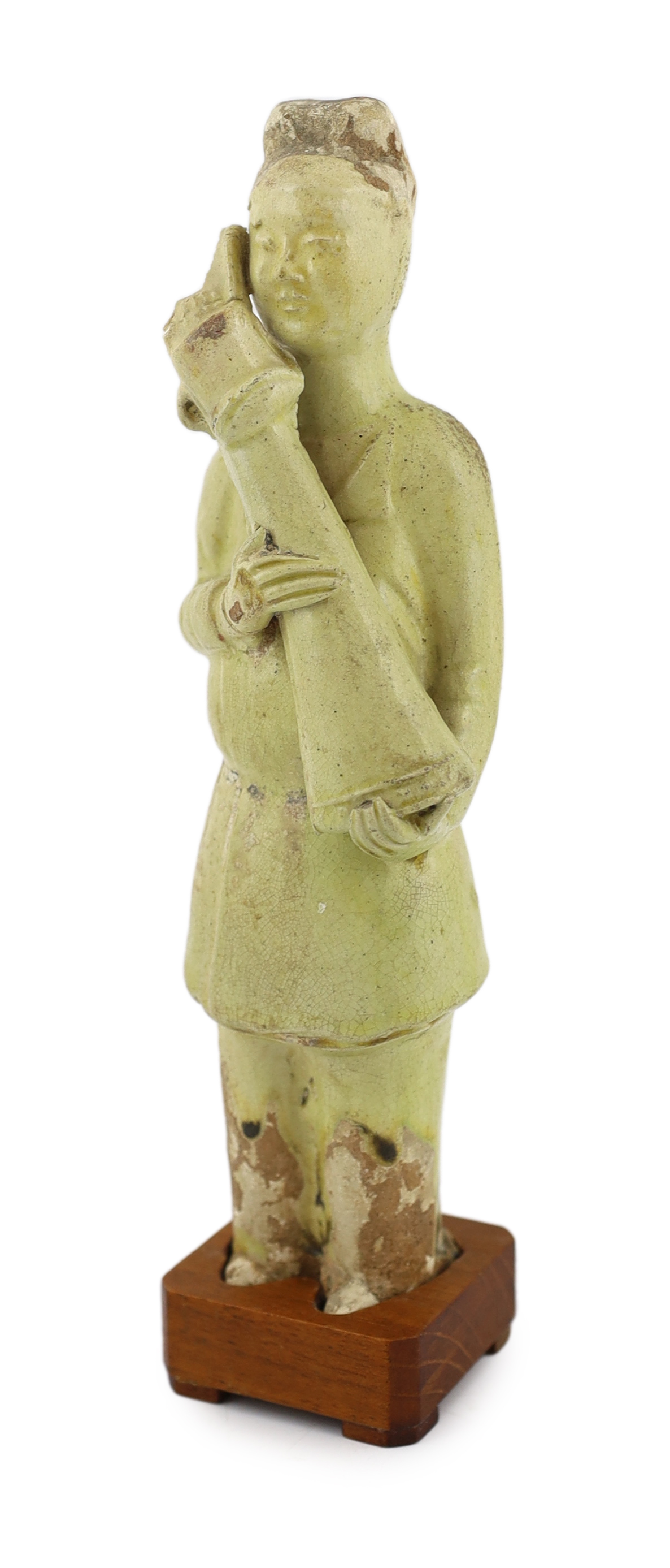 * A Chinese pale green glazed pottery figure of an attendant, Tang dynasty (618-906 AD),