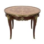A Louis XVI style ormolu mounted marquetry centre table, decorated with musical, agricultural and