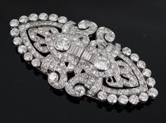 An Art Deco white gold, round and baguette cut diamond set double clip brooch, the largest stones