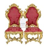 * An important pair of late 18th century Venetian carved baroque giltwood throne chairs, the seats